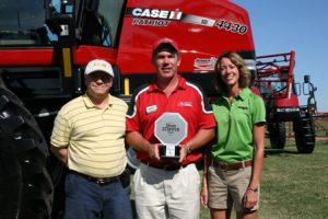 Mark Burns of Case IH poses with the 2012 CropLife Iron ShowStopper award in front of the winning product, the 4430 Patriot sprayer. Also, pictured are Iron editor Eric Sfiligoj and Jean Payne of the Illinois Fertilizer & Chemical Association.