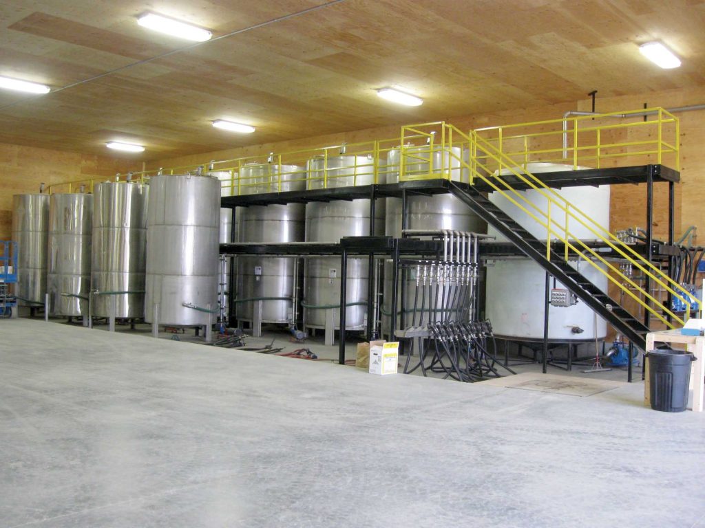 Chemical Storage Tank System with Catwalk and step down dike area at Cooperative Elevator recessed in floor for safe and easy access.