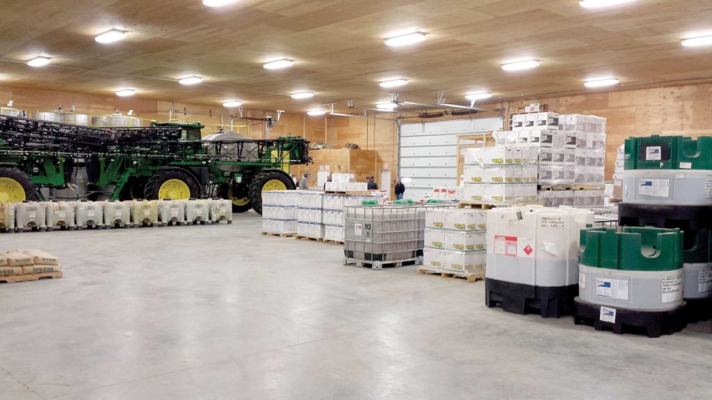 The warehouse floor is roomy enough to not only store products, but self-propelled sprayers that are not in use.