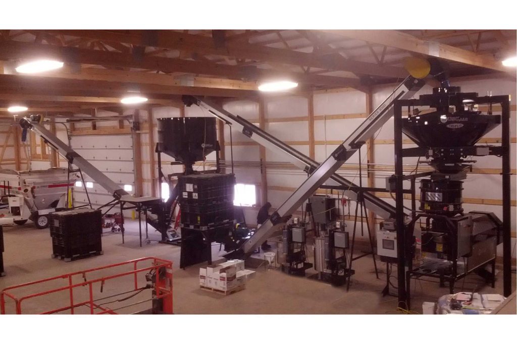 Gumz Seed Service’s USC seed treating equipment. This versatile set-up allows the facility to pull seed in from outdoor bins as well as boxes for treating. The treated seed can be packaged in tenders, boxes, bags, or whatever the customer wants.