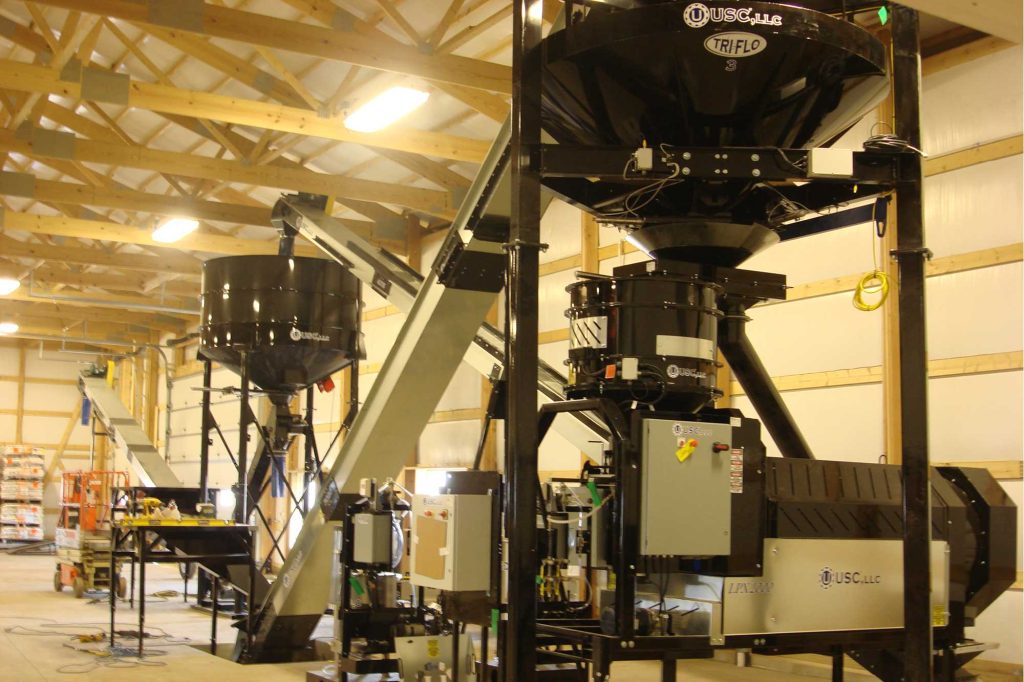 This floor-level angle shows the treater to the vibrating hopper.