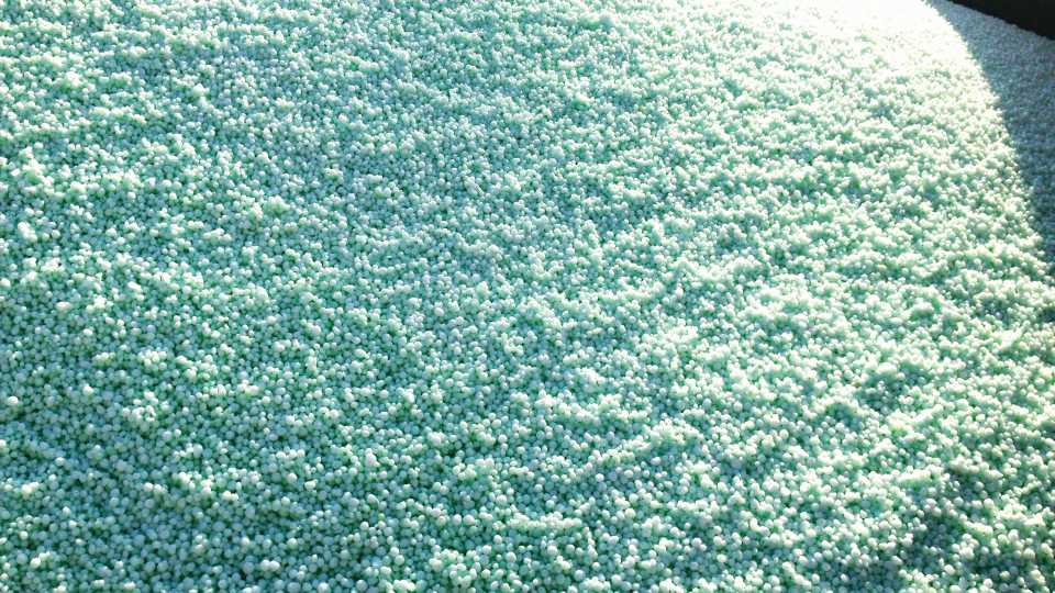 Uniform coverage of impregnated fertilizer Coated Urea
